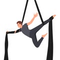 Young man hanging in aerial silk