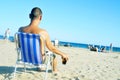 Young man hanging out on the beach, with a glass with cola drink Royalty Free Stock Photo