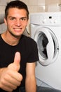 Young man happy with washing mashine Royalty Free Stock Photo