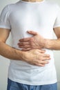 A young man has a stomach ache. Chronic gastritis. The concept of bloating. Royalty Free Stock Photo