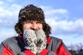 Young man with hat and coat shivering from cold Royalty Free Stock Photo