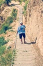 Young man in a hat goes down the stairs Royalty Free Stock Photo