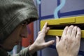 Young man with hat looking in the mailbox Royalty Free Stock Photo