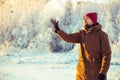 Young Man in hat playing with snow Outdoor Winter