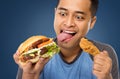 Young Man have a great desire to eat a burger Royalty Free Stock Photo