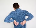 Young man having back pain. on white