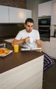 Man having breakfast and reading newspaper Royalty Free Stock Photo