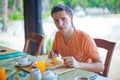 Young man having breakfast at resort restaurant Royalty Free Stock Photo