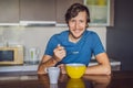 Young man having breakfast with tasty milk at home Royalty Free Stock Photo