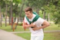 Young man having chest pain outdoors