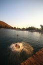 The young man is having fun by jumping into the sea on the Karaincir beach of the popular holiday destination Bodrum. Royalty Free Stock Photo