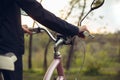 Close up of young man having fun near countryside park, riding bike, traveling at spring day Royalty Free Stock Photo