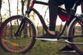 Close up of young man having fun near countryside park, riding bike, traveling at spring day Royalty Free Stock Photo