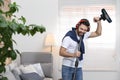 Young man having fun while vacuuming Royalty Free Stock Photo
