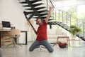 Young man having fun while vacuuming in living room Royalty Free Stock Photo