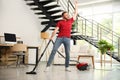 Young man having fun while vacuuming in living room Royalty Free Stock Photo