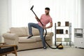 Young man having fun while vacuuming Royalty Free Stock Photo