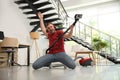 Young man having fun while vacuuming in living room Royalty Free Stock Photo