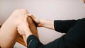 Young man having his knee examined by specialist. Physiotherapy knee flexibility Royalty Free Stock Photo