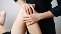 Young man having his knee examined by specialist. Physiotherapy knee flexibility Royalty Free Stock Photo