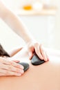 Young man having a massage with hot stones Royalty Free Stock Photo