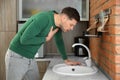 Young man having nausea in kitchen Royalty Free Stock Photo