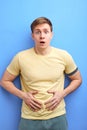 young man having painful stomach ache, chronic gastritis or abdomen bloating