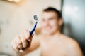 Young man having a shaving daily morning grooming routine by himself,using a razor.Hygiene skin body care concept.Facial hair Royalty Free Stock Photo