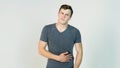 Young man having a stomachache on white background. Young man holds the stomach, it hurts