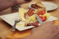 A young man is having a traditional english breakfast with bacon and eggs. Top view. Wooden table. Royalty Free Stock Photo