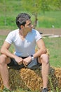 Young man on hay bale Royalty Free Stock Photo