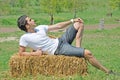 Young man on hay bale Royalty Free Stock Photo
