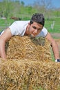 Young man on hay bale Royalty Free Stock Photo