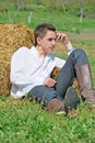 Young man on hay bale Royalty Free Stock Photo