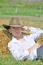 Young man on hay bale Royalty Free Stock Photo