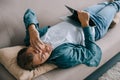 young man with headache lying on sofa Royalty Free Stock Photo