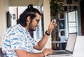 Young man with headphones asking for speaking studying virtually