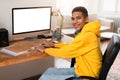 Young man with headphones at computer workstation Royalty Free Stock Photo