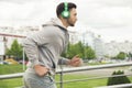 Young man with headphones jogging outdoors