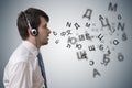 Young man with headphones is learning different foreign languages.