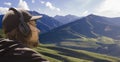 Young man in headphones listening music in nature and at the mountain