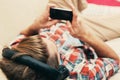 Young man in headphones with mobile phone relaxing home Royalty Free Stock Photo