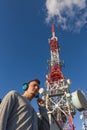 Young Man with Headphones Side Telecommunications Antenna