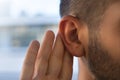 Young man with hearing problems, hearing loss or hard of hearing Royalty Free Stock Photo