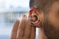 Young man with hearing problems or hearing loss. Hearing test concept. Royalty Free Stock Photo