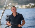 Young man at the helm of a sailing yacht. Sport. Royalty Free Stock Photo