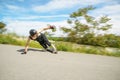 Young man in helmet is going to slide, slide with sparks on a longboard on the asphalt Royalty Free Stock Photo