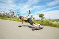 Young man in helmet is going to slide, slide with sparks on a longboard on the asphalt Royalty Free Stock Photo