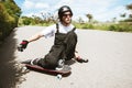 Young man in helmet is going to slide, slide with sparks on a longboard on the asphalt Royalty Free Stock Photo