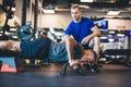 Young man helping senior man in a workout. Royalty Free Stock Photo